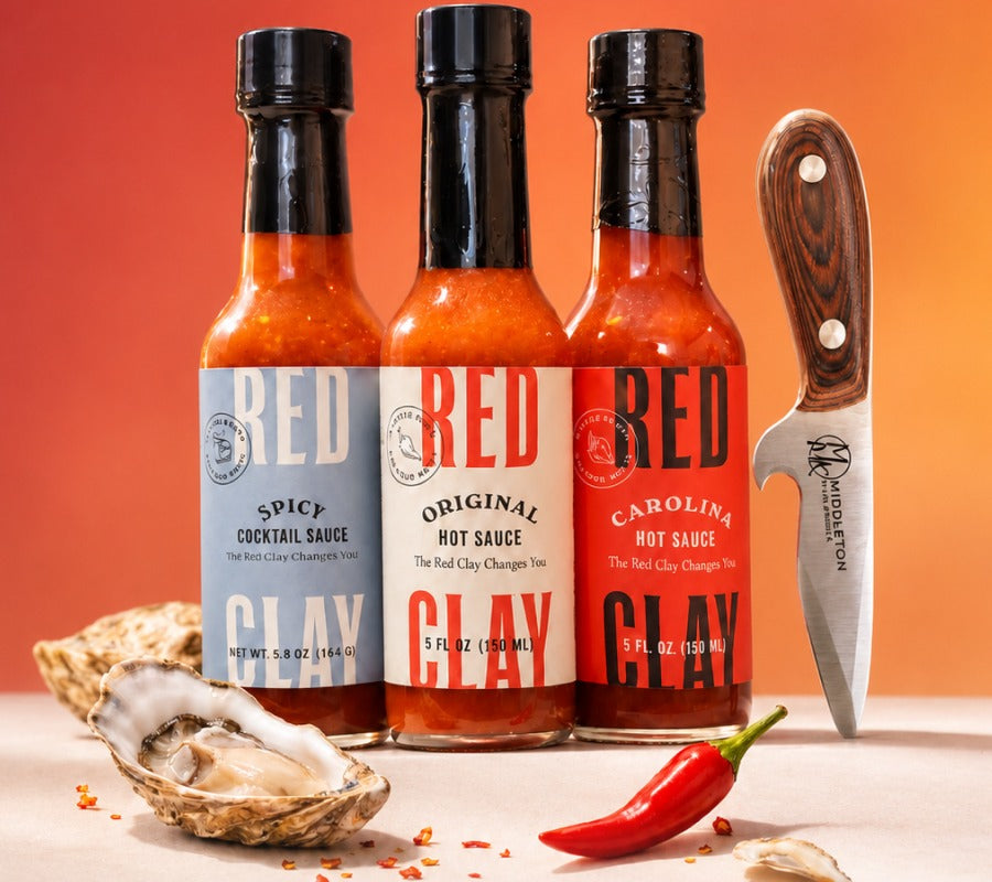 Spicy Cocktail Sauce, Original Hot Sauce, Carolina Hot Sauce, and Middleton Made oyster knife with a shucked oyster